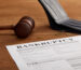 bankruptcy form with wooden gavel, coins and wallet on brown wooden table